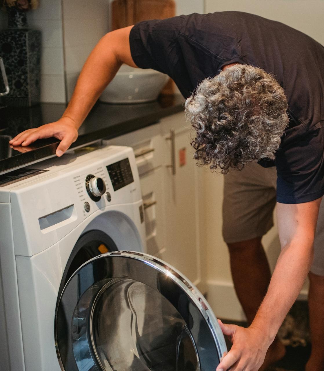 Caregiver folding laundry in a bright, tidy home